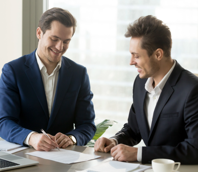 handsome-businessman-signing-contract-with-partner